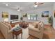Bright living room featuring neutral-toned sofas, a large window, terracotta tile floors, and stylish decor at 5265 Myakka Rd, De Leon Springs, FL 32130