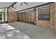 Covered patio boasts brick exterior, concrete flooring, and screened enclosure at 5265 Myakka Rd, De Leon Springs, FL 32130