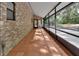 Covered patio with brick exterior, tile flooring, and screened enclosure at 5265 Myakka Rd, De Leon Springs, FL 32130