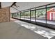 Large enclosed porch with mixed flooring and brick detail offers an expansive view of the outdoors at 5265 Myakka Rd, De Leon Springs, FL 32130