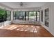 Sunroom with tile floor and many windows with nature painting offering ample natural light and scenic views at 5265 Myakka Rd, De Leon Springs, FL 32130