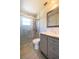 Updated bathroom featuring a shower with glass doors and a gray vanity with marble countertop at 5519 Silent Brook Dr, Orlando, FL 32821