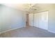 Comfortable bedroom offers tile floors, a ceiling fan, and ample closet space at 5519 Silent Brook Dr, Orlando, FL 32821