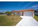 Exterior of a single-story house featuring a well-manicured front lawn and a driveway at 5519 Silent Brook Dr, Orlando, FL 32821