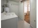 Practical laundry area with appliances, shelving, and adjacent storage space at 5519 Silent Brook Dr, Orlando, FL 32821