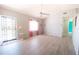 Bright living room with tile floors, ceiling fan, and a view to front door at 5519 Silent Brook Dr, Orlando, FL 32821