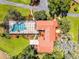 Aerial view of a beautiful estate home with a screened pool, well-maintained landscaping and mature trees at 5549 Aragon Ave, De Leon Springs, FL 32130
