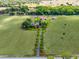 Majestic estate with a long driveway, picturesque landscaping, and ample space for outdoor activities and equestrian pursuits at 5549 Aragon Ave, De Leon Springs, FL 32130