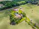 Estate home with pool, gardens, and outbuildings on meticulously landscaped grounds and surrounded by grassy fields at 5549 Aragon Ave, De Leon Springs, FL 32130