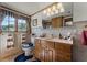 Bathroom featuring a wood vanity, a decorative mirror, and a window with patterned valances at 5549 Aragon Ave, De Leon Springs, FL 32130