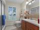 An on-suite bathroom featuring a window with plantation shutters and a tile backsplash at 5549 Aragon Ave, De Leon Springs, FL 32130