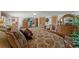 Spacious bedroom featuring warm neutral tones and wooden furnishings on a tile floor at 5549 Aragon Ave, De Leon Springs, FL 32130