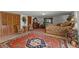 Comfortable bedroom featuring warm neutral tones and a distinctive area rug on the tile flooring at 5549 Aragon Ave, De Leon Springs, FL 32130