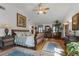 Bright and airy bedroom with vaulted ceilings, large windows, hardwood floors and a comfortable seating area at 5549 Aragon Ave, De Leon Springs, FL 32130