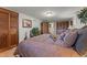 Bedroom with warm tones, stylish decor, and ample closet space at 5549 Aragon Ave, De Leon Springs, FL 32130