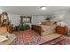 Inviting bedroom showcasing warm, neutral colors and wooden furnishings on a tile floor at 5549 Aragon Ave, De Leon Springs, FL 32130