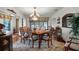 Elegant dining room with wooden table, decorative rug, and natural light creating an inviting atmosphere for gatherings at 5549 Aragon Ave, De Leon Springs, FL 32130