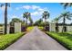 Long private driveway leading to the house lined with palm trees, foliage, and a fence at 5549 Aragon Ave, De Leon Springs, FL 32130