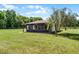 Back exterior view of a home with a screened in porch and large yard at 5549 Aragon Ave, De Leon Springs, FL 32130