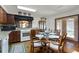Kitchen featuring hardwood floors, wood cabinets, tile countertops and breakfast table with seating at 5549 Aragon Ave, De Leon Springs, FL 32130