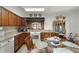 Kitchen featuring hardwood floors, wood cabinets, tile countertops and breakfast table with seating at 5549 Aragon Ave, De Leon Springs, FL 32130