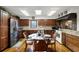 Kitchen featuring hardwood floors, wood cabinets, stainless steel appliances and breakfast table with seating at 5549 Aragon Ave, De Leon Springs, FL 32130