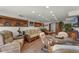 Cozy living room with wicker furniture, stone floors, recessed lighting and natural elements at 5549 Aragon Ave, De Leon Springs, FL 32130