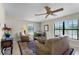 Comfortable living room with neutral walls, a ceiling fan, a large sofa, and a side chair at 5549 Aragon Ave, De Leon Springs, FL 32130