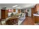 Bright living room featuring tile floors, neutral decor, and comfortable seating arrangements for relaxing and entertaining at 5549 Aragon Ave, De Leon Springs, FL 32130