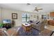 Comfortable living room with neutral walls, a ceiling fan, large sofa and trunk-style coffee table at 5549 Aragon Ave, De Leon Springs, FL 32130