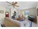 Comfortable living room with neutral walls, a ceiling fan, a large sofa, and a side chair at 5549 Aragon Ave, De Leon Springs, FL 32130