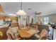 Open concept living room and kitchen with tiled floors, ceiling fan, and dining table at 5549 Aragon Ave, De Leon Springs, FL 32130