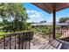 View from a porch showing the stairs, landscaping, and pool in the distance at 5549 Aragon Ave, De Leon Springs, FL 32130