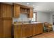 A bright wet bar area featuring oak cabinets, stainless sink, and natural light enhancing the functionality and ambiance at 5549 Aragon Ave, De Leon Springs, FL 32130