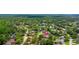 Aerial view of a residence in a community with verdant foliage and scenic water features, offering a tranquil setting at 6 Leisure Wood Way, Ormond Beach, FL 32174