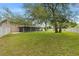 Lush backyard featuring a screened patio at 6 Leisure Wood Way, Ormond Beach, FL 32174
