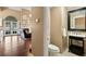 Powder room featuring a black framed mirror and single sink with a decorative cabinet at 6 Leisure Wood Way, Ormond Beach, FL 32174