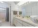 Well-lit bathroom featuring a vanity, towels and adjacent toilet and tub area at 6 Leisure Wood Way, Ormond Beach, FL 32174