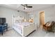 Bedroom with beachy decor, ensuite bathroom, ceiling fan, and bright natural light at 6 Leisure Wood Way, Ormond Beach, FL 32174
