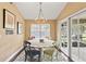 Breakfast nook with colorful chairs and sliding glass doors to the outdoor patio at 6 Leisure Wood Way, Ormond Beach, FL 32174
