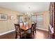 Cozy dining room featuring hardwood floors, a chandelier, and a window with natural light at 6 Leisure Wood Way, Ormond Beach, FL 32174
