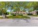 Inviting brick home with a well-kept lawn, circular driveway, and mature trees creating a welcoming curb appeal at 6 Leisure Wood Way, Ormond Beach, FL 32174