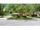 Charming brick home with well-manicured landscaping, mature trees, and a circular driveway enhancing its curb appeal at 6 Leisure Wood Way, Ormond Beach, FL 32174