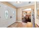 Inviting entryway with double doors, tiled floor, and a glimpse into the dining room beyond at 6 Leisure Wood Way, Ormond Beach, FL 32174