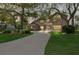 Charming brick home featuring a spacious driveway, mature trees, and a beautifully landscaped yard, offering a serene setting at 6 Leisure Wood Way, Ormond Beach, FL 32174