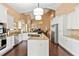 Bright, open kitchen featuring an island, granite countertops, stainless appliances and white cabinetry at 6 Leisure Wood Way, Ormond Beach, FL 32174