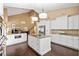 Bright, open kitchen featuring an island, granite countertops, stainless appliances and white cabinetry at 6 Leisure Wood Way, Ormond Beach, FL 32174