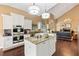 Bright, open kitchen featuring granite countertops, stainless appliances and white cabinetry at 6 Leisure Wood Way, Ormond Beach, FL 32174