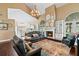 Bright and spacious living room featuring high ceilings, a fireplace, and seamless flow to the kitchen at 6 Leisure Wood Way, Ormond Beach, FL 32174