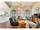Open-concept living room with vaulted ceilings, a cozy fireplace, and views of the adjacent kitchen at 6 Leisure Wood Way, Ormond Beach, FL 32174